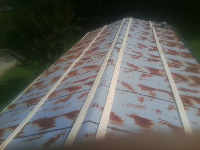 Rusted metal roof panels with new wood purlins before replacement — Storm Damage Roof Repair in East Haddam by Roofing Brothers