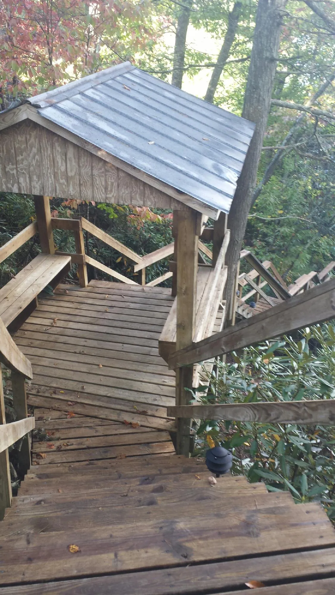 Metal roofed shelter over wooden steps on a wooded walkway — Skylight Repair & Installation work by our crew in East Haddam