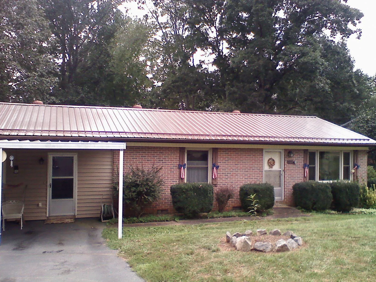 Bronze metal roof and carport on a brick ranch home — Roof Repair work by our crew in East Haddam