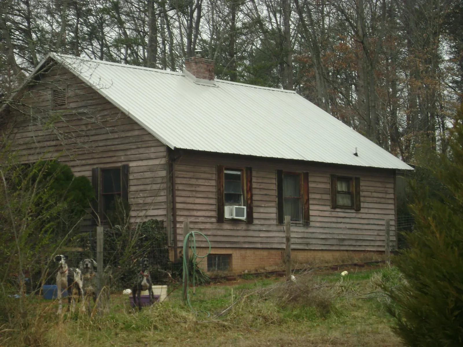 White metal roof on an old wood sided farmhouse, from a Metal Roof Installation job in East Haddam